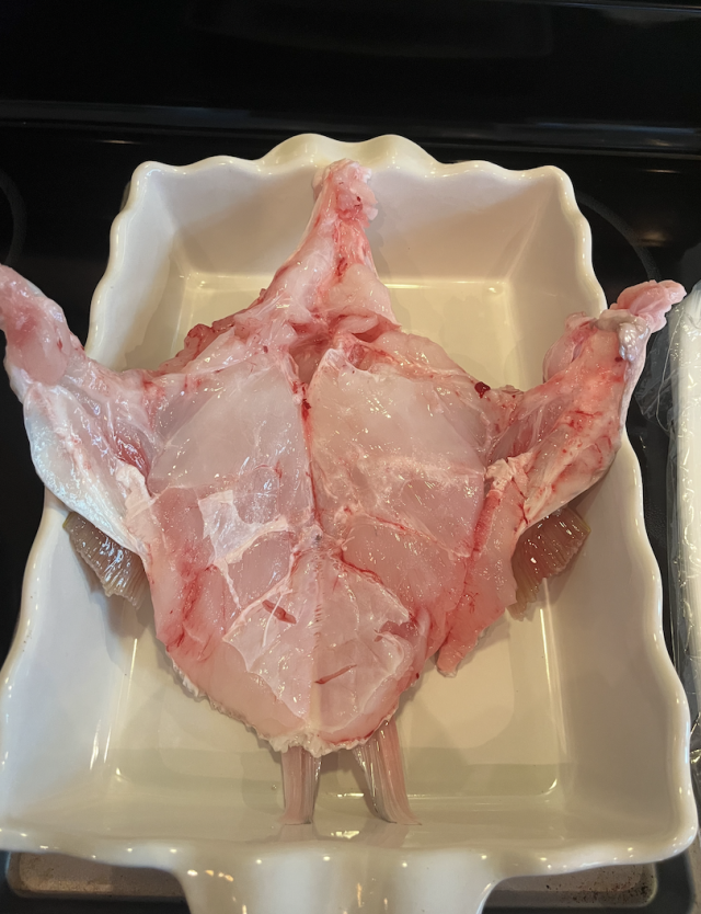 A fish throat laying in a baking pan.