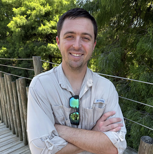 Picture of a man standing on a boardwalk.